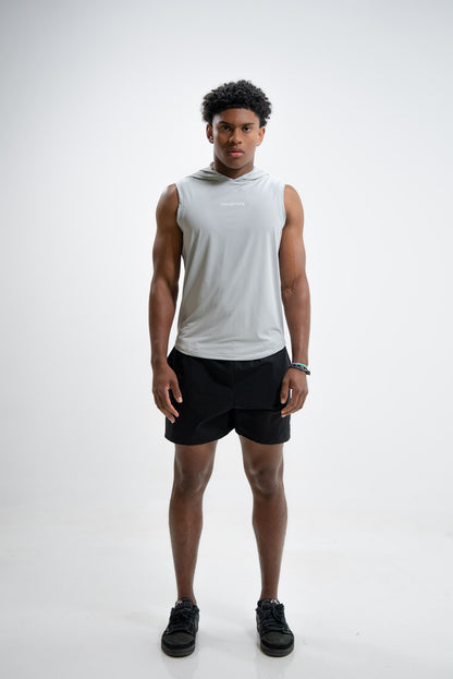 Man wearing a sleeveless white hoodie and black shorts on a white background